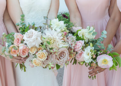 bouquets of white and pink flowers and roses with green foliage