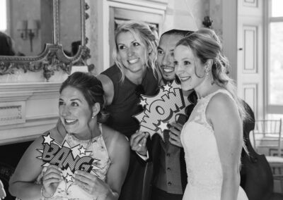 bride and friends at wedding photo booth in drawing room