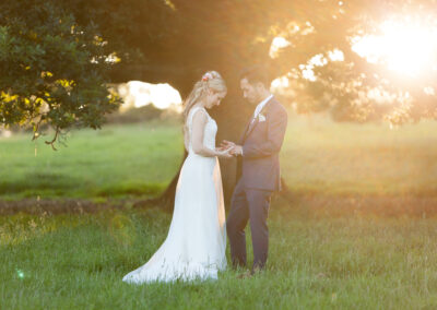 Bride and groom in Devon field at sunset