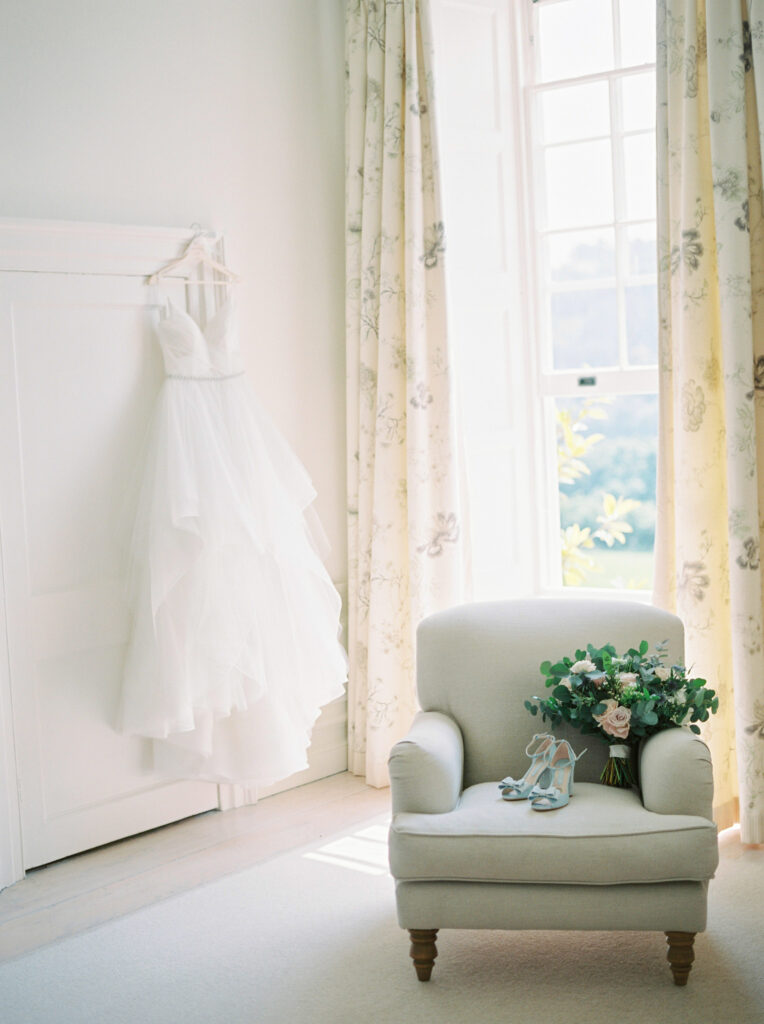 Wedding dress hanging up before wedding in bridal suite
