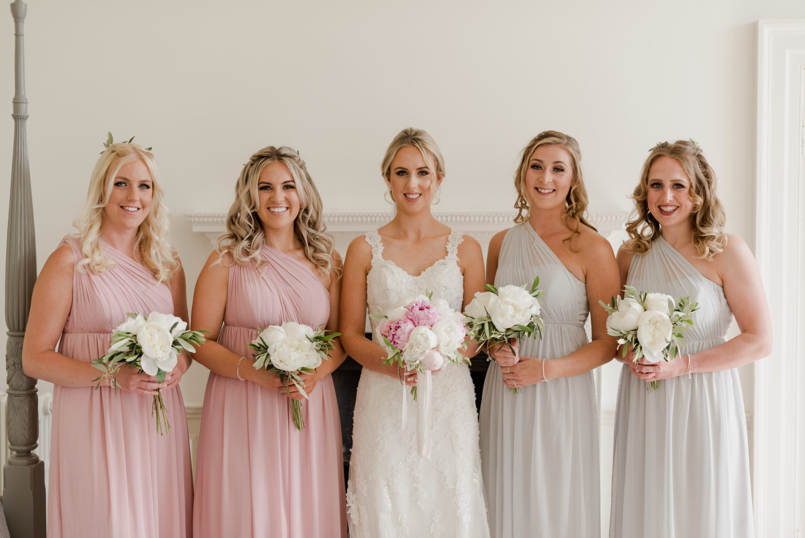 Bride standing with four bridesmaids.