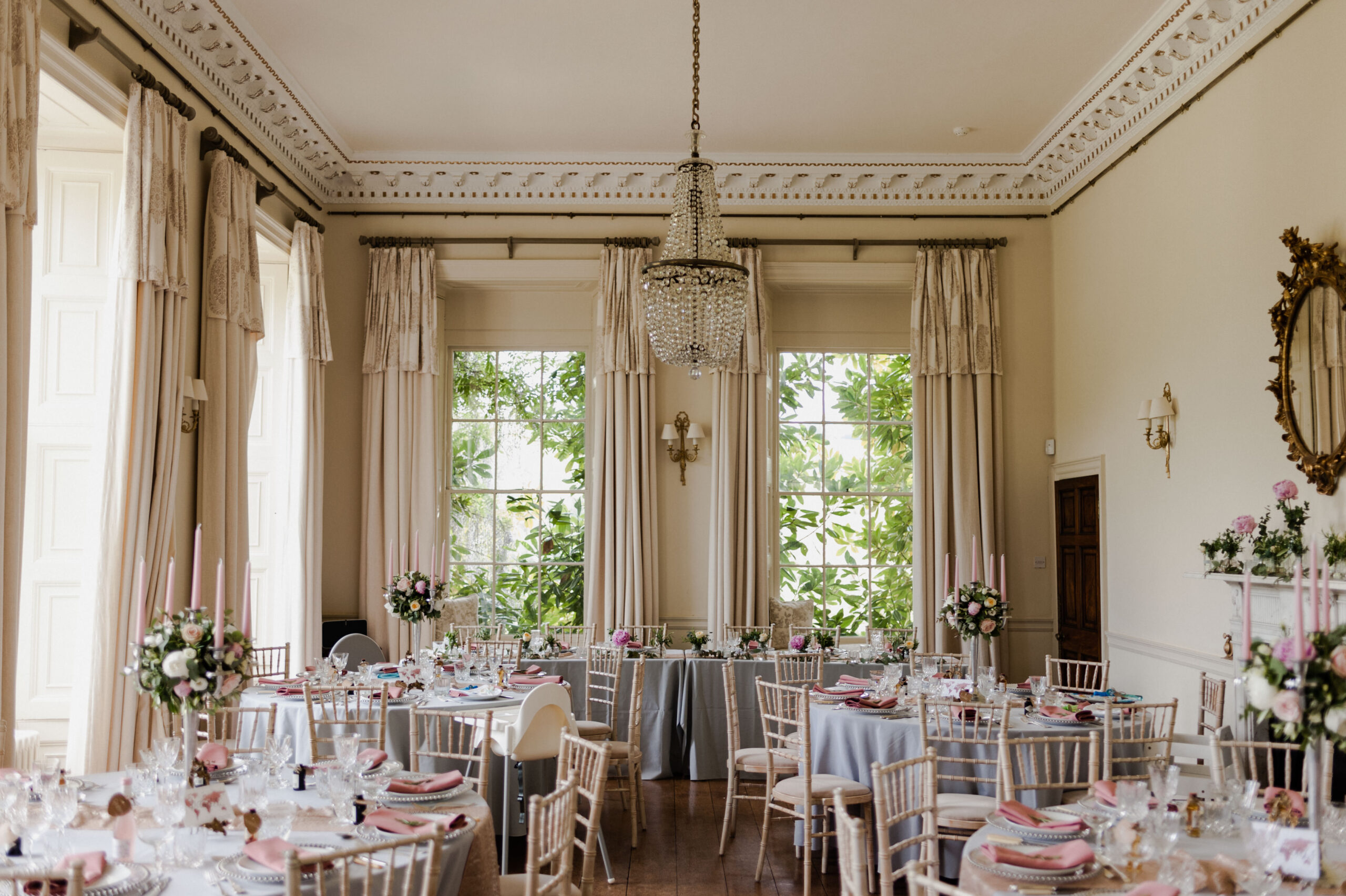 Wedding reception setup of circular tables in a ballroom.