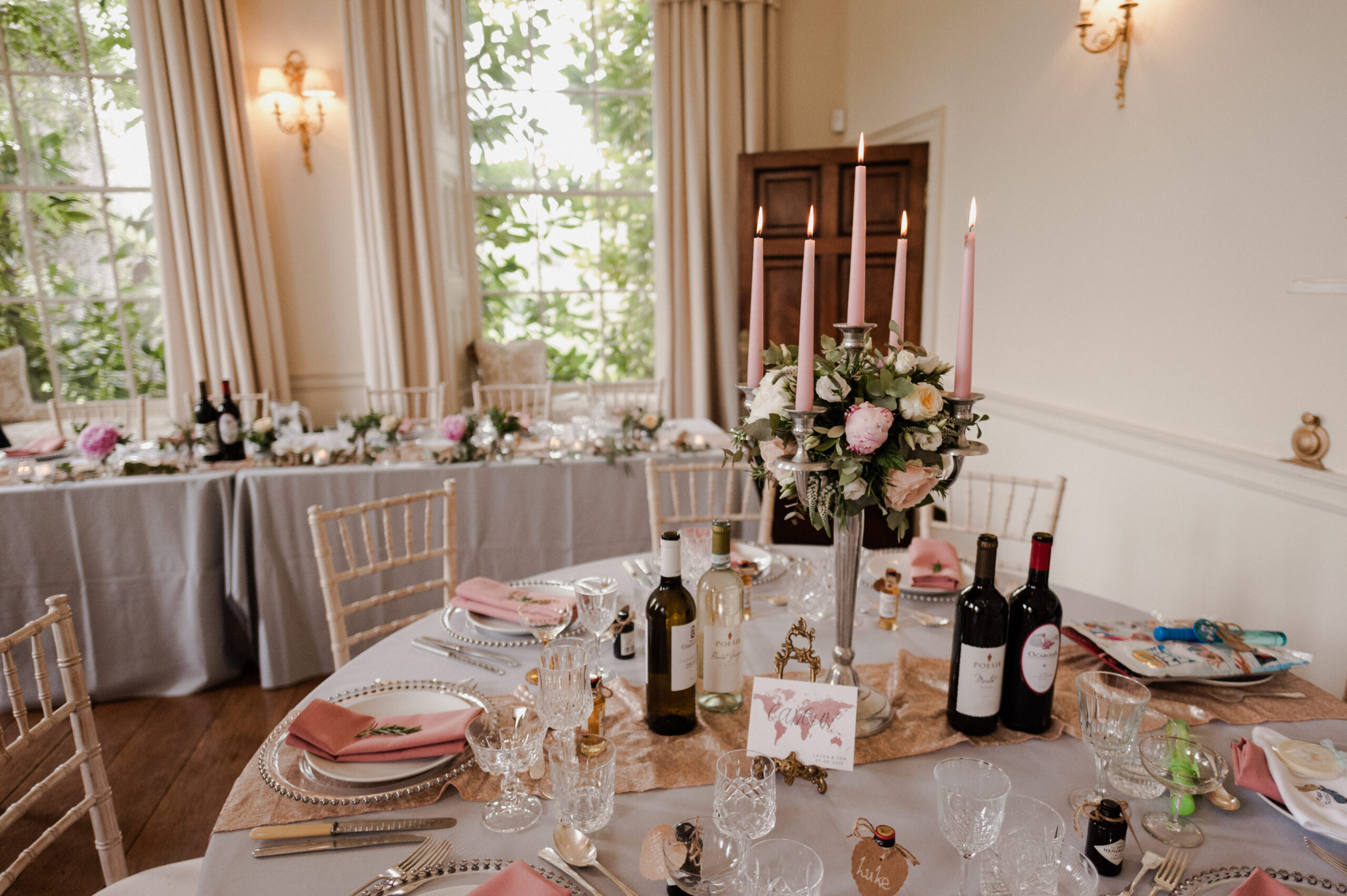 Wedding reception setup of circular tables in a ballroom.