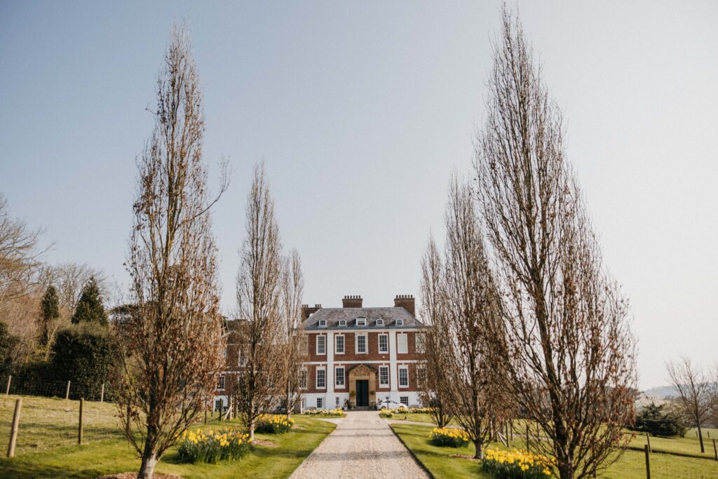 English country house with daffodils, in spring.