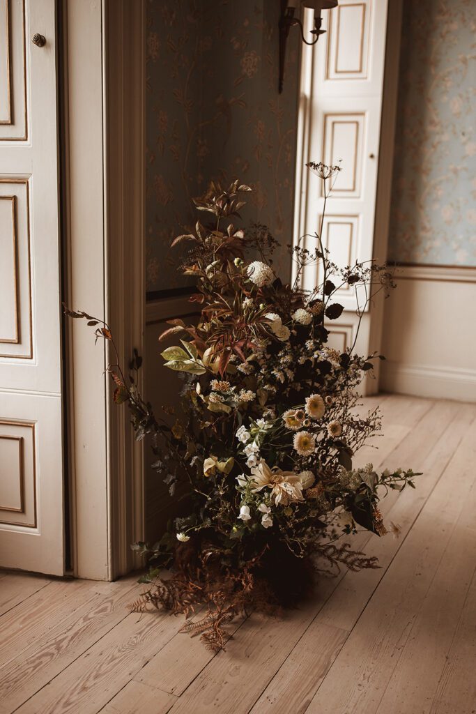Abundant floral arrangement of flowers and foliage.