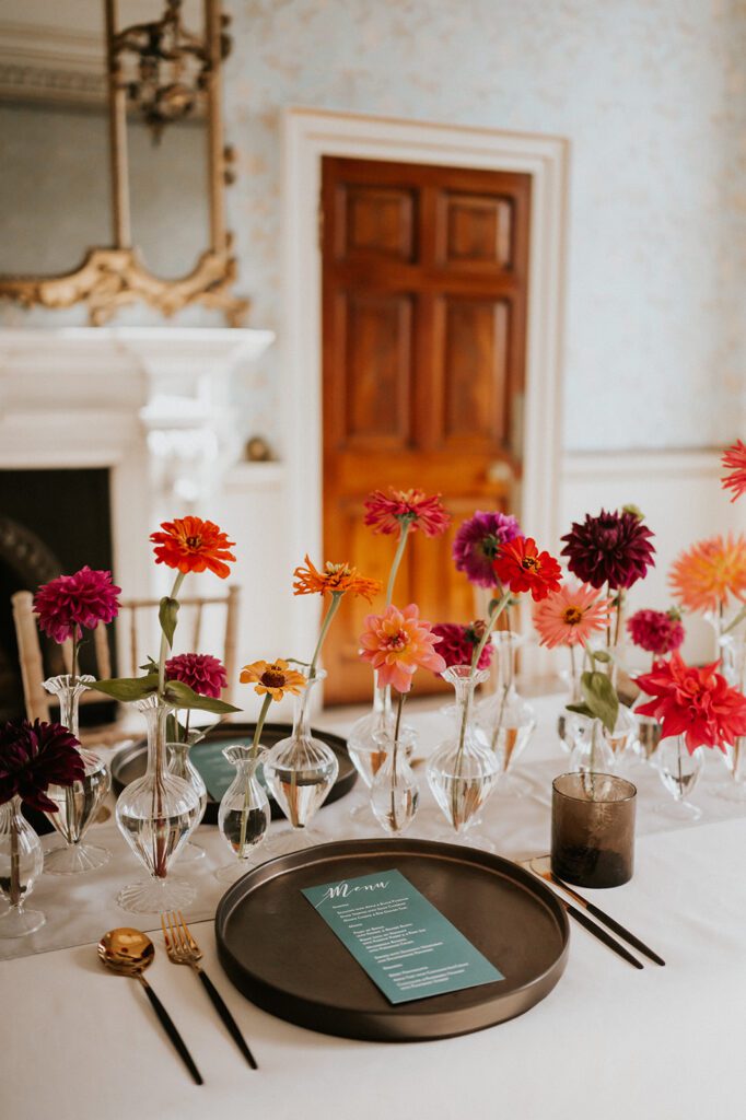 Sustainably sourced wedding flowers on dining table, for wedding reception.