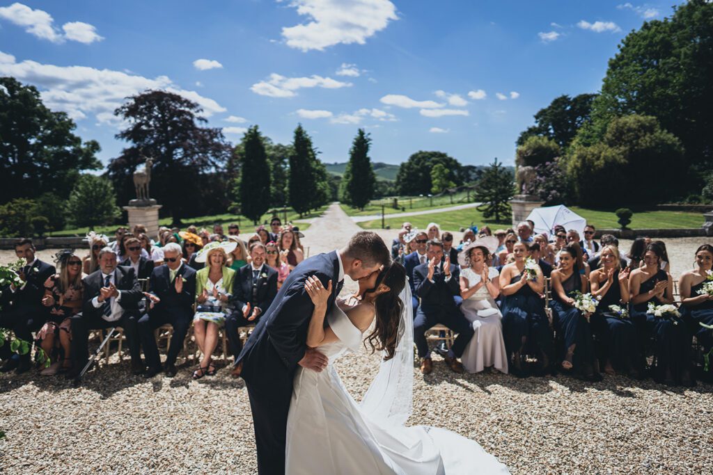 Bride and groom at the altar during an outdoor wedding ceremony, at Pynes House.
