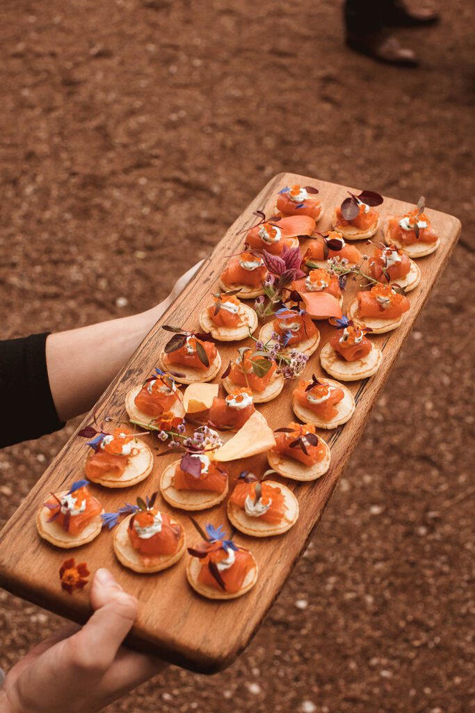 Canapés during wedding reception, with edible flowers.