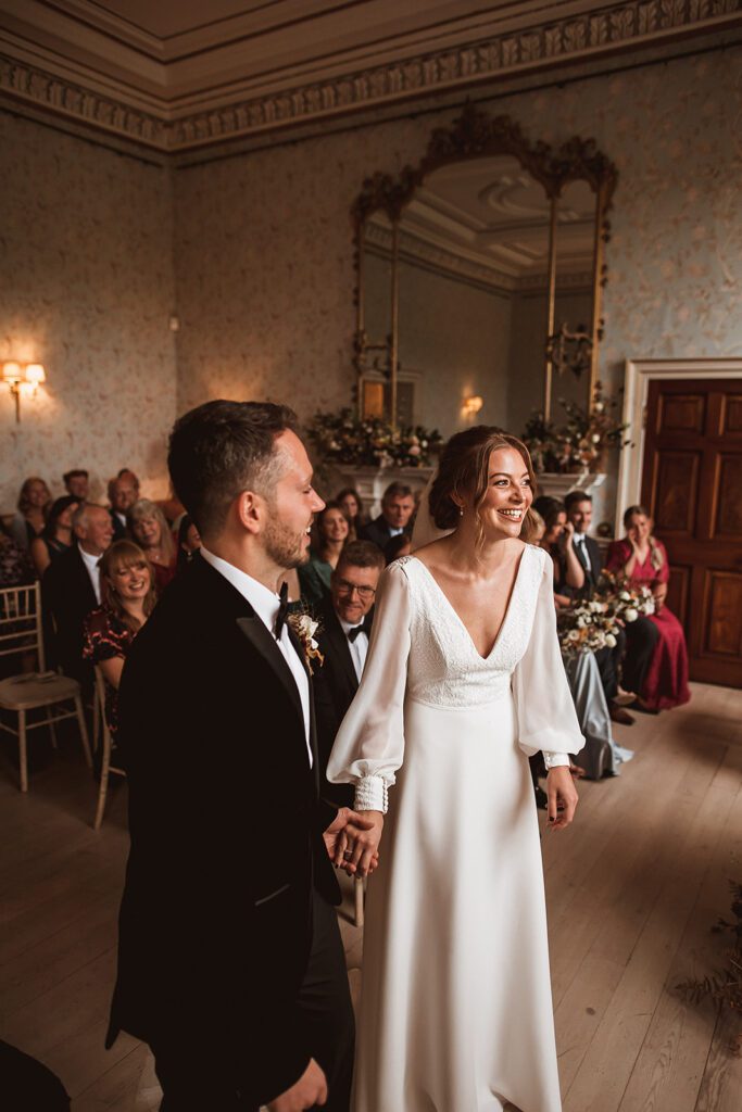 Bride and groom standing at altar, at Pynes House.