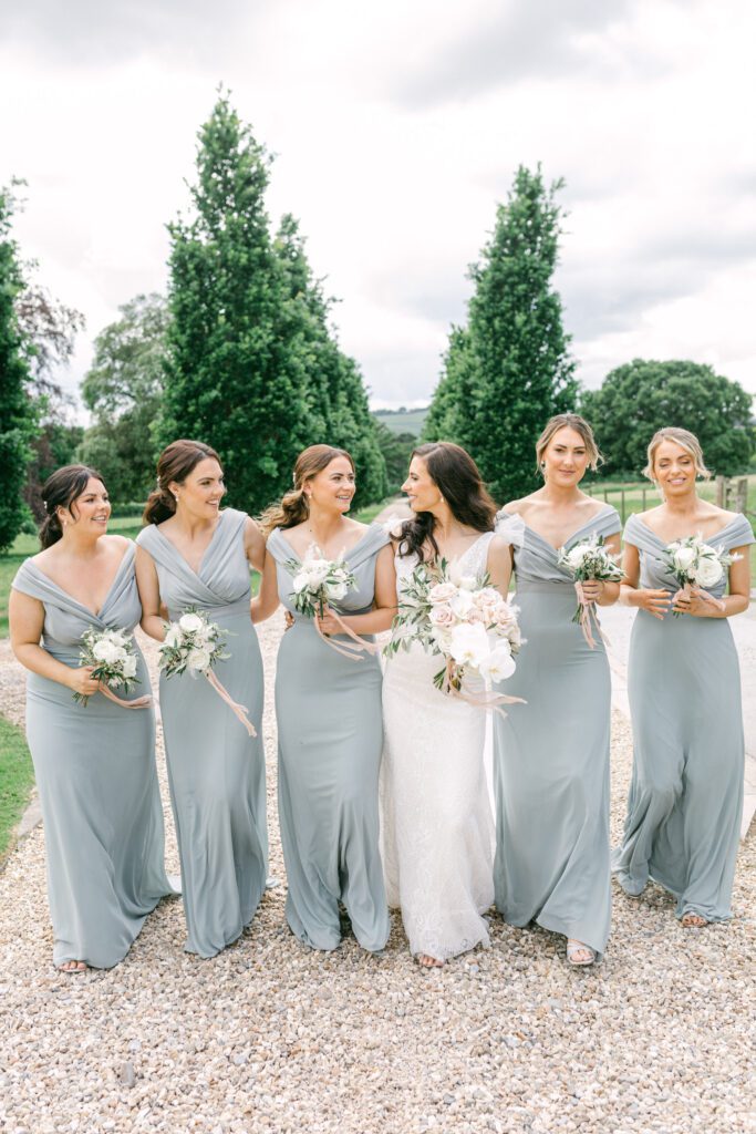 Bride with bridesmaids, at stately home wedding venue.