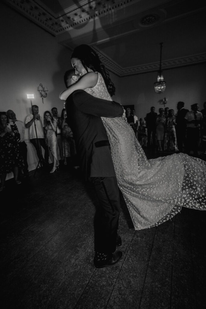 A bride and groom enjoy their first dance in the ballroom at Pynes House.