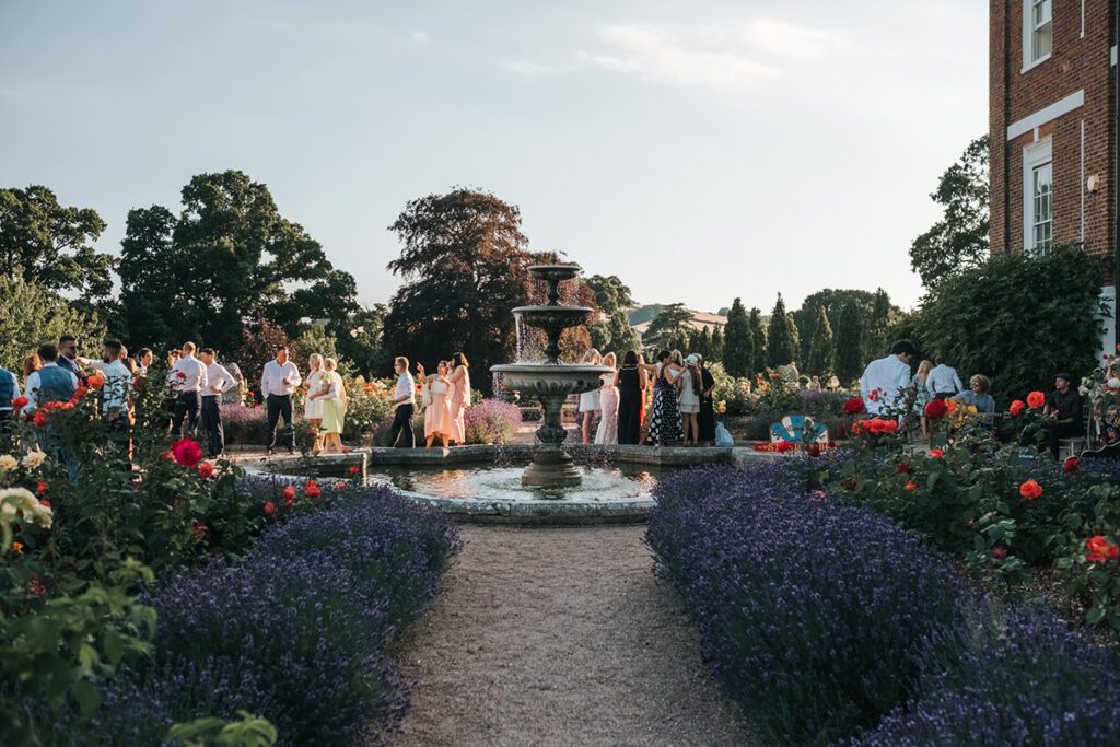Outdoor drinks reception for a summer wedding at Pynes House in Devon
