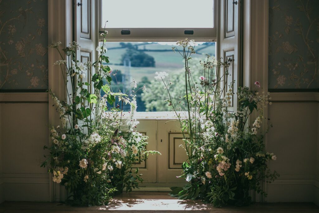 Natural wedding florals for a wedding ceremony at Pynes House in Devon.