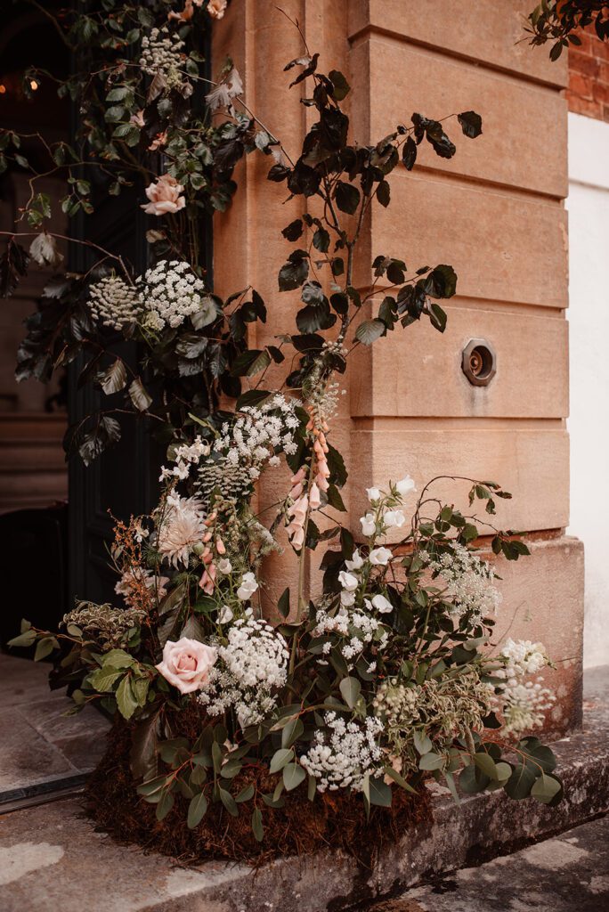 A floral arch display for a boho wedding at Pynes House.