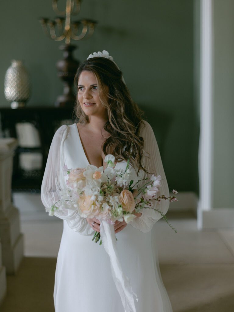 A bridal portrait as an elegant bride holds her bouquet