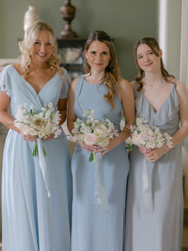 Three bridesmaids dressed in blue, for an English wedding.