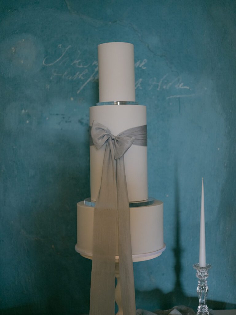A luxury wedding cake with a bow, for a stately home wedding at Pynes House wedding venue