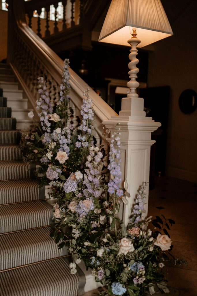 A stairway decorated with flowers, for a wedding weekend.