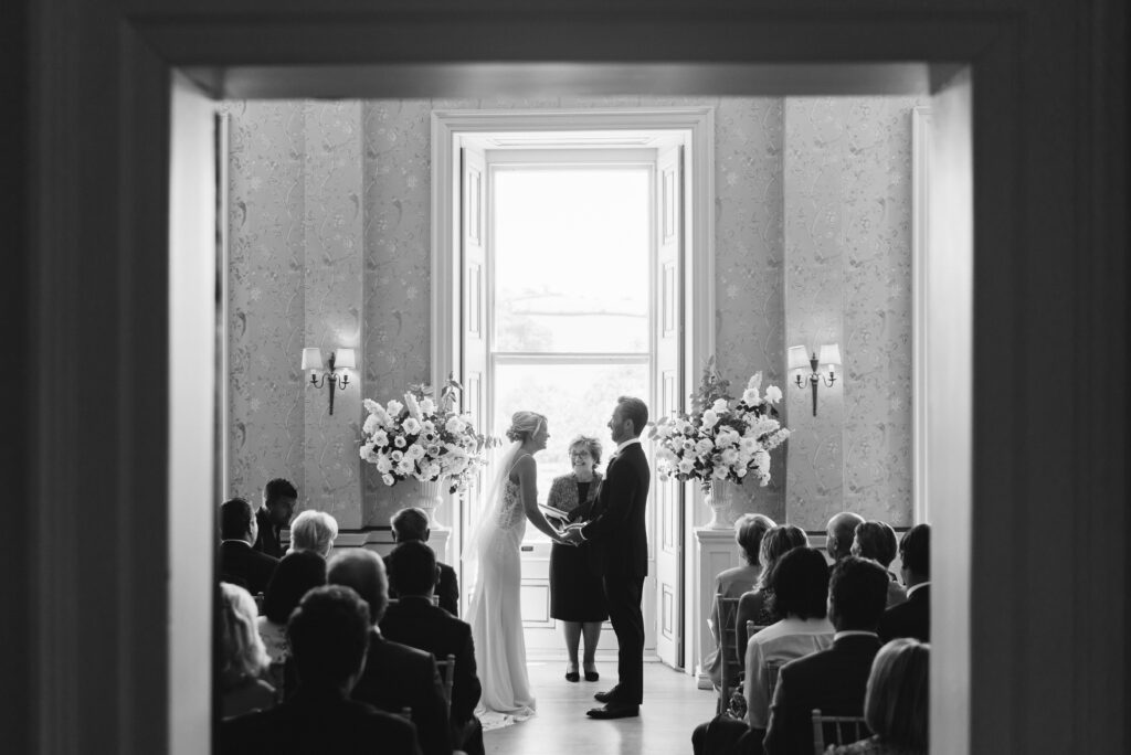 A bride and groom say their vows at a stately home wedding venue near London.