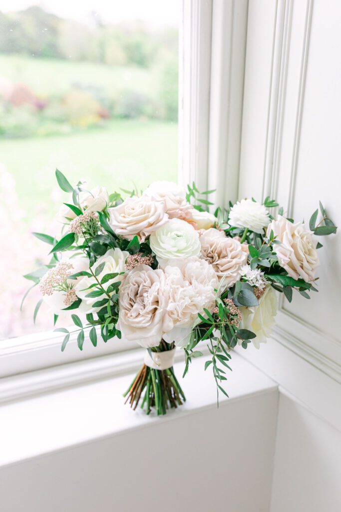 A bouquet of pastel coloured wedding flowers for a English country garden wedding