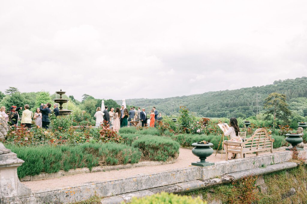 Wedding entertainment ideas of a wedding painter during an outdoor wedding reception