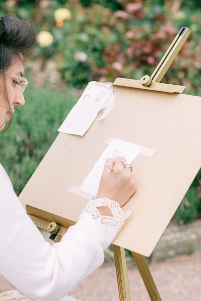 Wedding entertainment ideas of a live wedding painter in the gardens of Pynes House