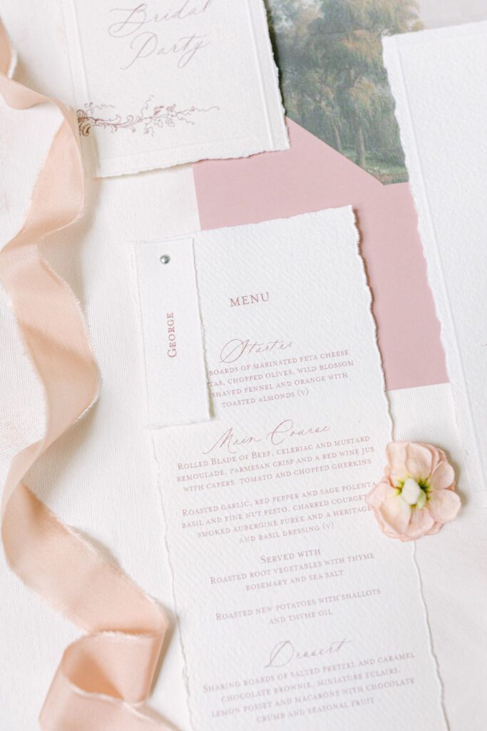 A flat lay of classic and elegant wedding stationery