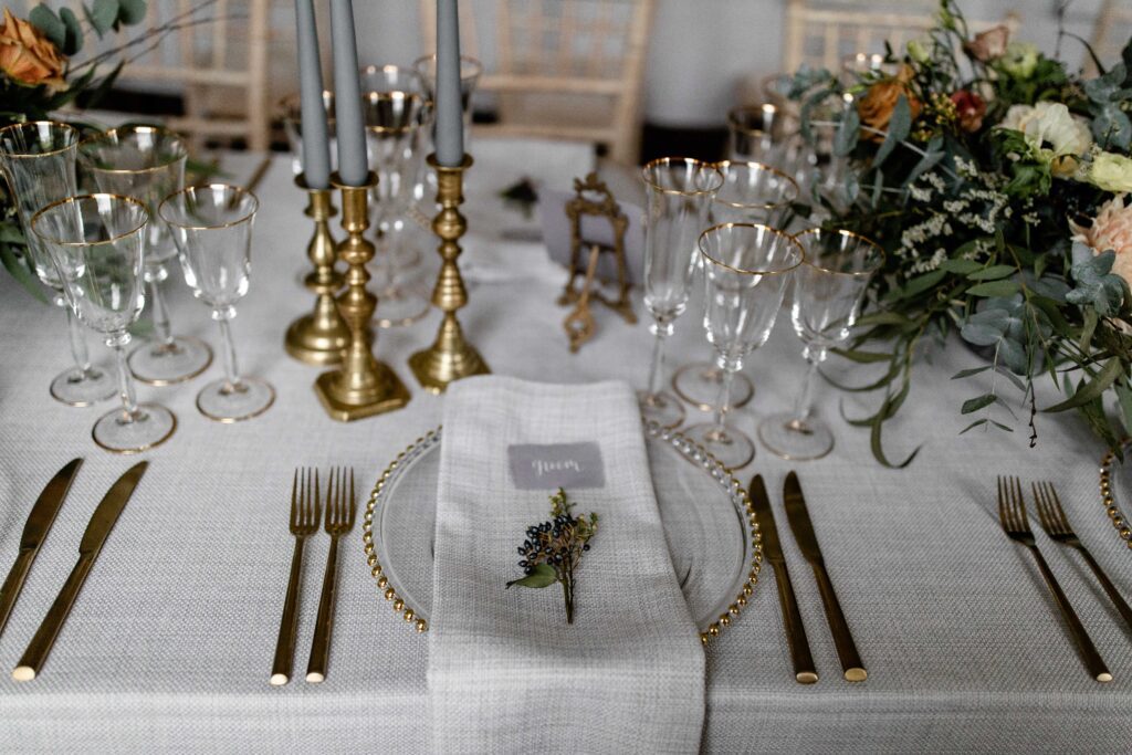 A place setting with mistletoe for a festive wedding reception at Pynes House