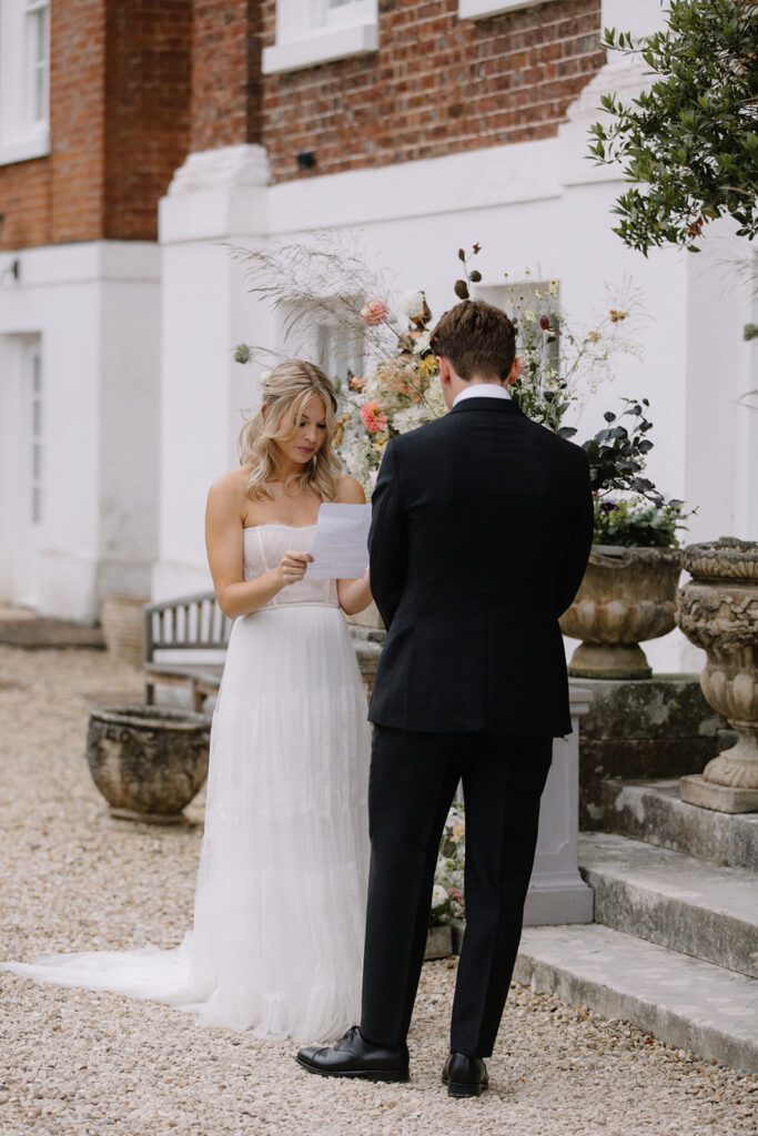 Bride reading vows to groom at Pynes House